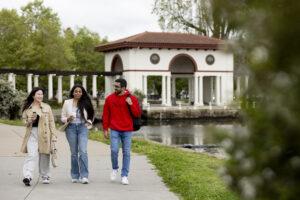 Three Oakland students walk by Lake Merritt